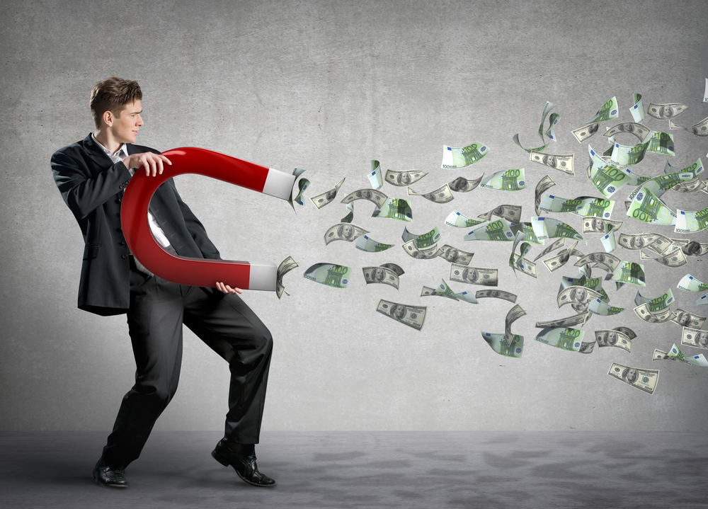 man attracting money with magnet